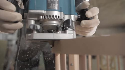 Carpenter Works with Electric Milling Cutter