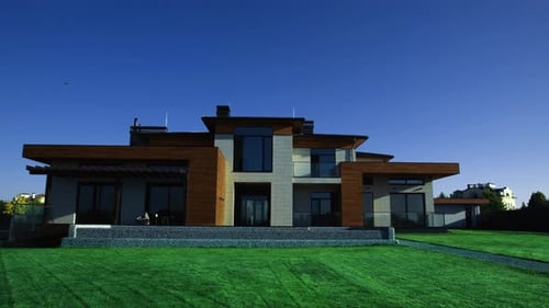 Modern House Exterior with Green Lawn on a Sunny Day