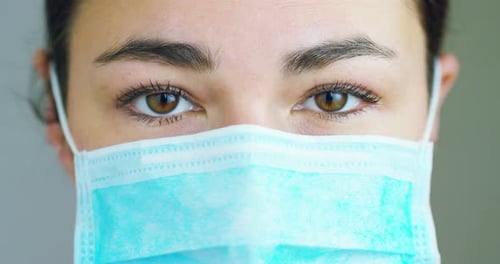 close up portrait of a woman surgeon or doctor with mask ready for operation in hospital or clinic