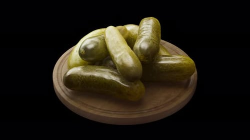 Rotating Delicious Pickled Cucumbers on a Wooden Cutting Board