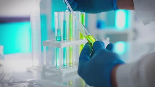Lab Worker Extracts Liquid from Test Tube