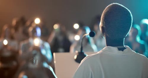 Speaker, podium and back of business woman at conference for finance summit, applause and seminar