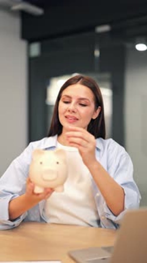 Happy Woman Saving Money in Piggy Bank for Future