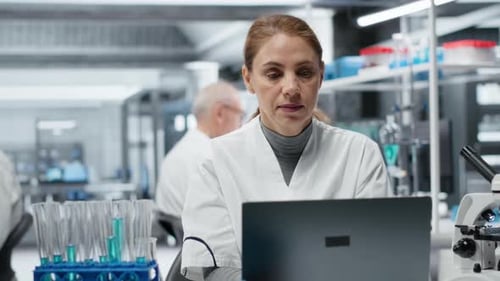 Woman Scientist Working on Laptop in Laboratory