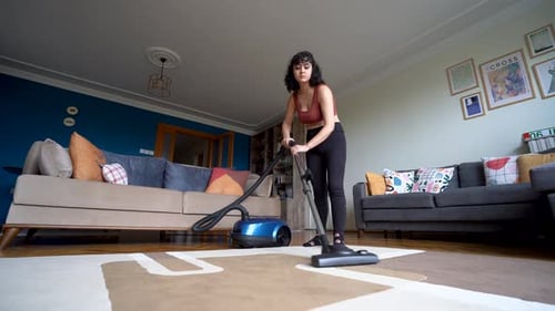 Woman Vacuuming Area Rug in Living Room