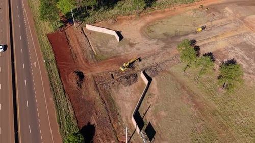 Aerial view of working on a roadside excavation in a suburban infrastructure site.