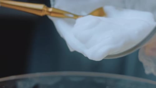 Thick White Cream Being Poured into Glass Bowl