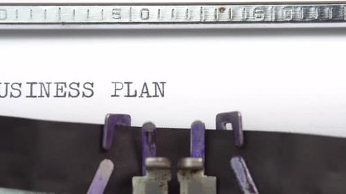 Geschäftsplan-Phrase, Nahaufnahme beim Tippen und zentriert auf einem Blatt Papier auf einer alten Vintage-Schreibmaschine