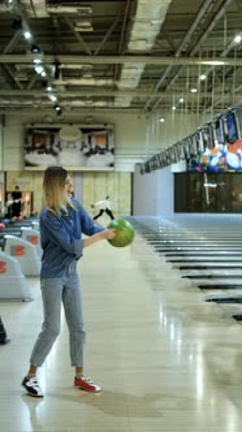 vertical video, woman throwing bowling ball