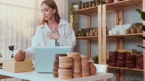 Woman Video Calling With Pottery in Home Office