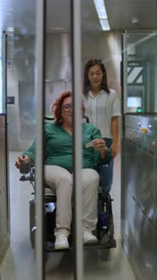 Woman Using Wheelchair Entering Subway with Friend
