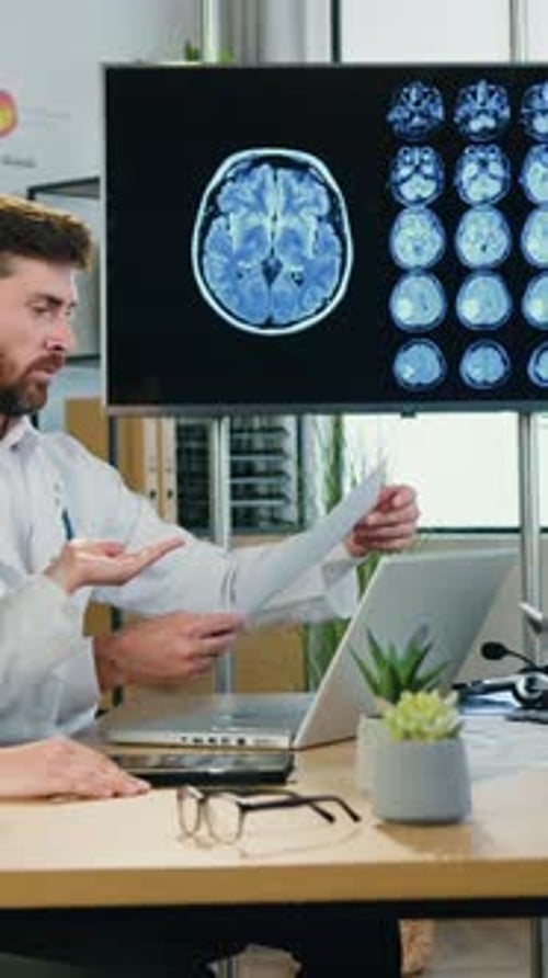 Doctors Reviewing Brain Scan Results in Office Setting