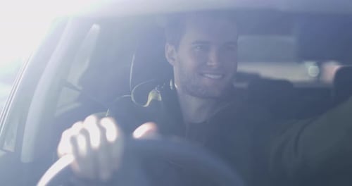 Driver adjusting rear view mirror