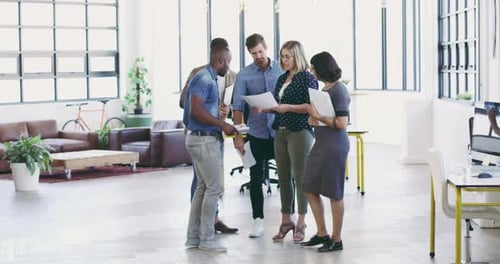 4K video footage of a diverse group businesspeople talking together in a modern office