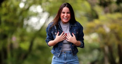Excited Woman Celebrates Success in Park Environment