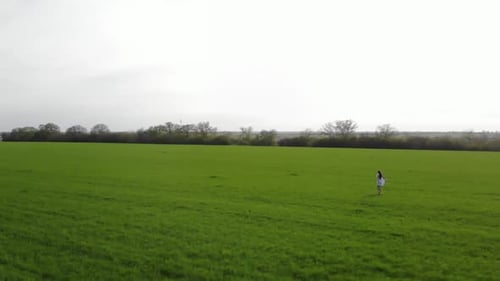 beautiful girl in white dress at the green field