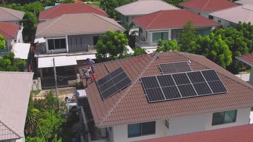 Drone view of engineer worker installed solar panels on roof of house.