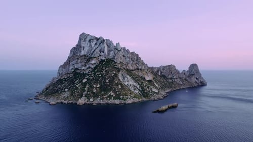 Majestic Island Rock Formation Surrounded By Calm Deep Blue Ocean