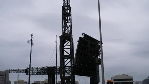 Rotating Radar Installation Against Overcast Urban Sky