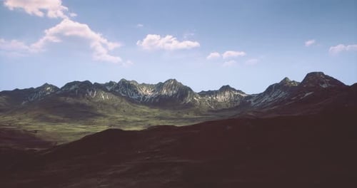 Majestic Mountain Range Under Clear Blue Sky in Natural Daylight