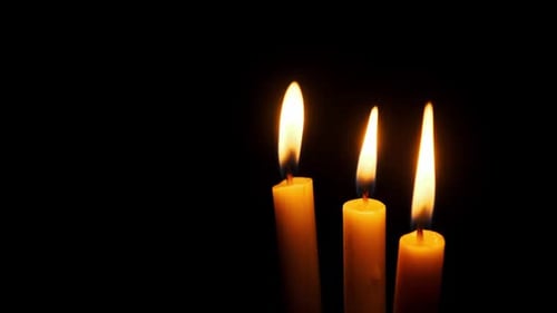 Three Candles Burning and Extinguished on a Black Background Copy Space