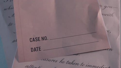 close up of empty case file envelope over vintage letter