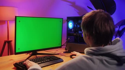 Computer with Chroma Key Green Screen on Monitor Gamer Man Playing in Popular Video Games Programmer
