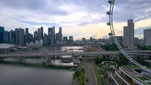 Aerial video of the Singapore city skyline featuring the Singapore Flyer observation ferris wheel, M