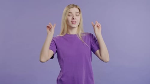 Woman Makes Peace Sign on Purple Background