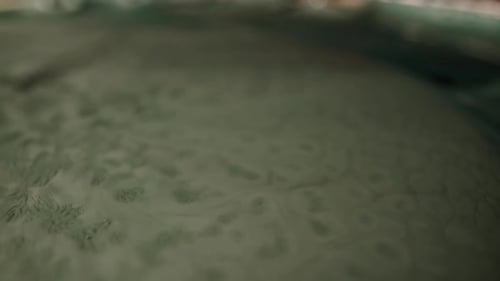Extreme Close up of dark grey fluid looking like sewage water. Particles on the surface of the fluid