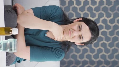 Woman With Sore Throat Sitting on Couch