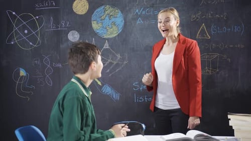 Teacher Explains Lessons to Student in Classroom