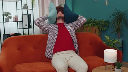 Man with Afro Wig Sitting on Couch