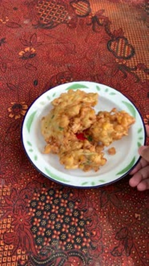 Plate of Crispy Fried Food on Batik Tablecloth