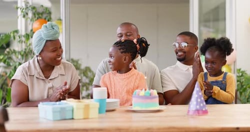 Family Celebrates Birthday with Cake and Gifts