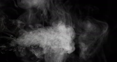 White smoke flowing over a black background