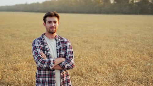 Portrait of Happy Farmer Standing in Ripe Wheat Field with Arms Crossed on Chest Proud Agronomist