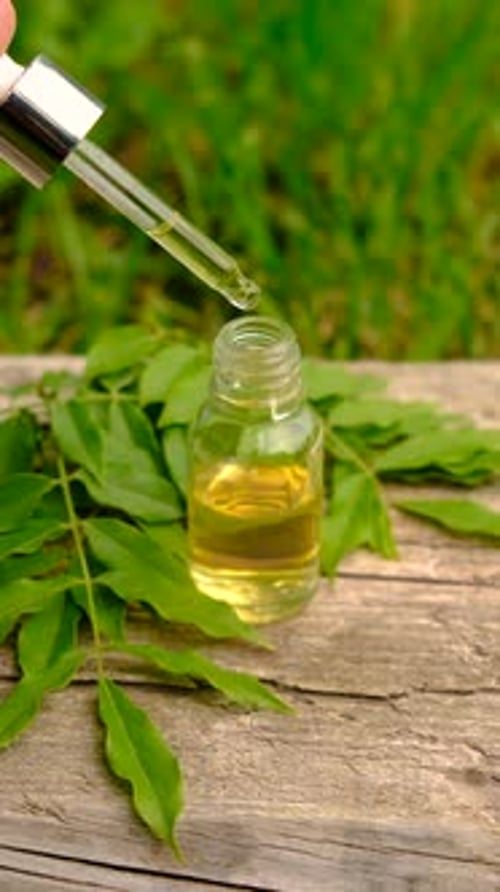 Close Up of a Hand Using a Dropper for Natural Essential Oil