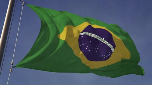Waving Brazilian Flag Against a Clear Blue Sky
