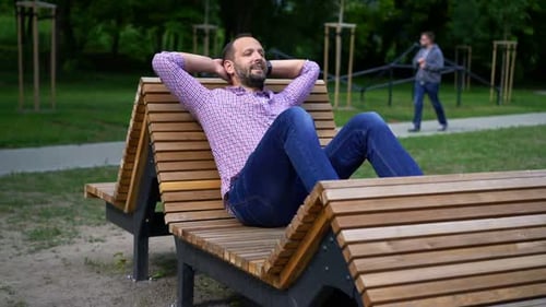 Young Man Relaxing in Urban Park