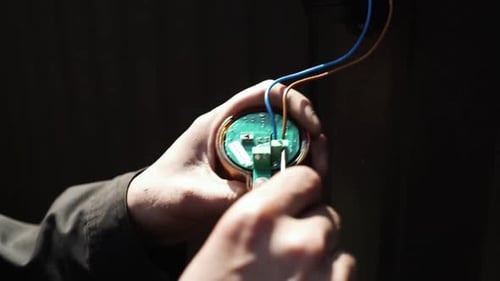 Electrician connects the yellow Signal Lamp for the gate. Warning yellow flash lamp