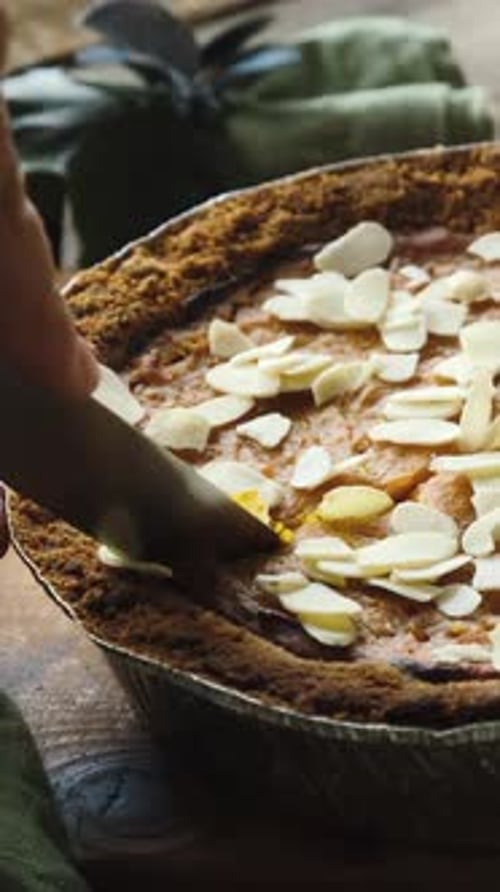Vertical Video Cutting Pumpkin Pie Sprinkled with Almonds