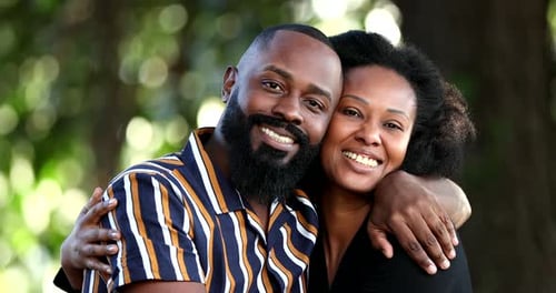 Smiling Couple Embrace in the Outdoors, Green Background