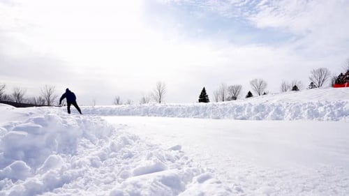 Person Ice Skating on Snowy Winter Rink