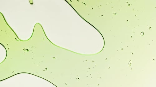 Transparent Green Cosmetic Gel Fluid With Molecule Bubbles and Oil on White Background