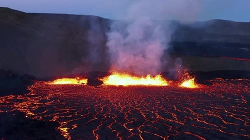 Iceland fissure volcano eruption at night with molten magma spewing, hell like landscape