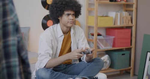 Teen Plays Video Games in Bedroom Setting