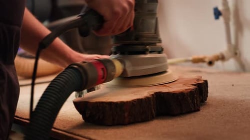 Woodworking Specialist in Furniture Assembly Shop Using Angle Grinder