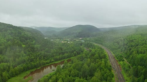 Camera Moving Forward Above Winding River and Countryside