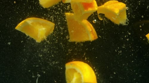 Fresh Orange Fruit Slices Falling Into Water